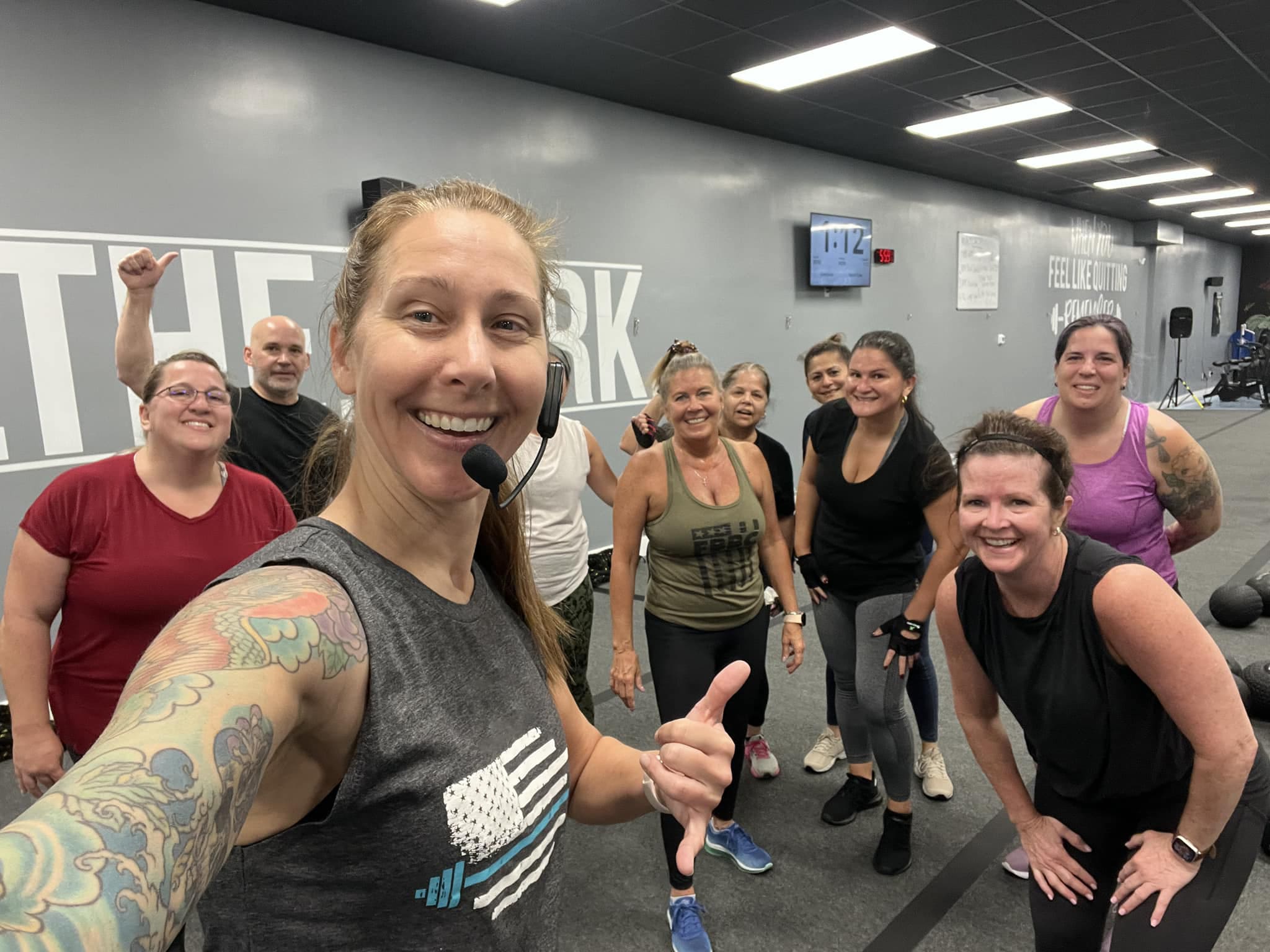 Coastal Fitness Coach posing with members after group fitness session