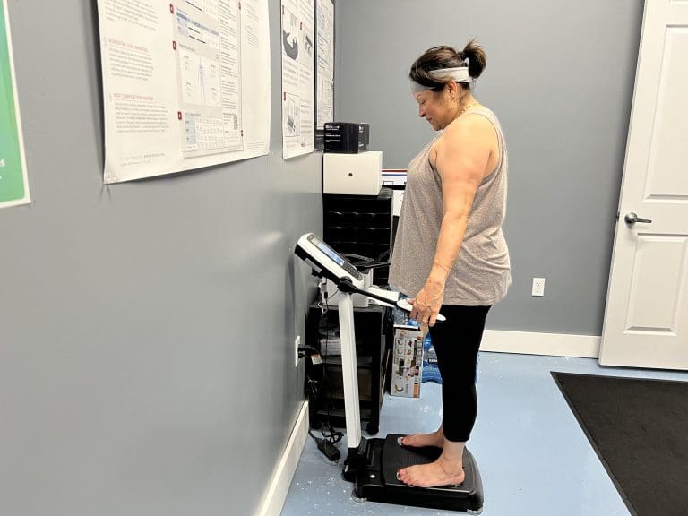 Member at Coastal Fitness taking a body composition scan for weight management