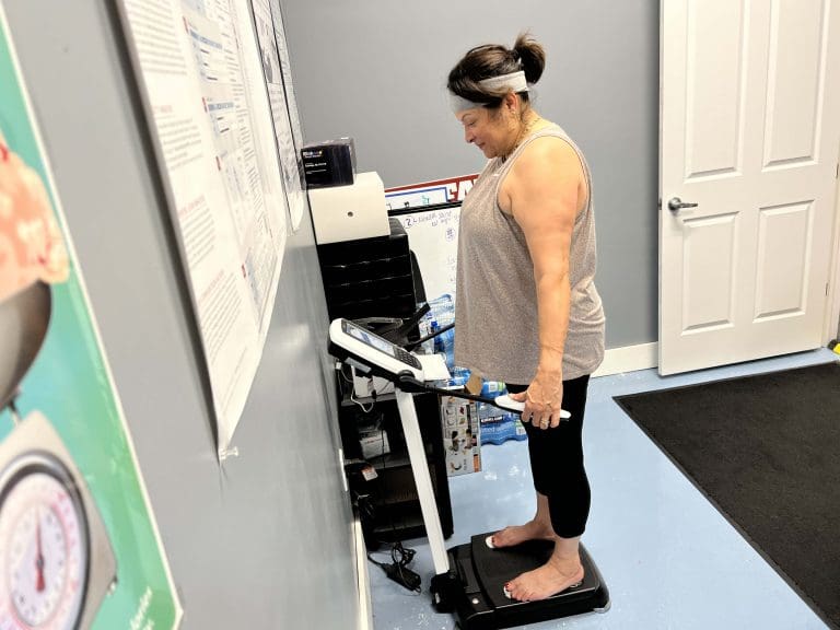 Member at Coastal Fitness taking a body composition scan for weight management