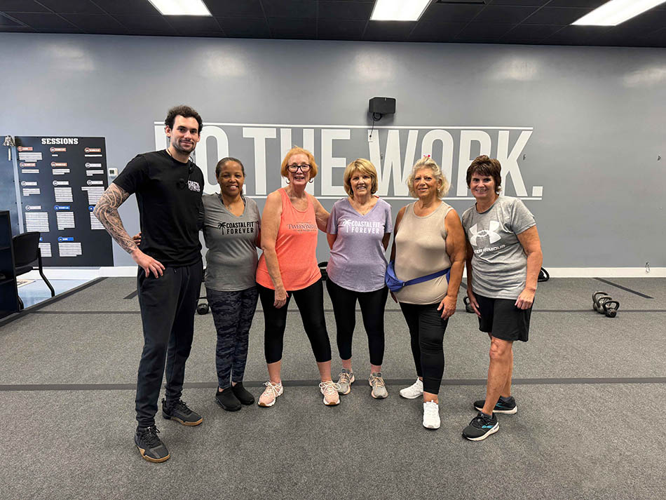Coastal Fitness 55 and older members posing for a group photo after strength training
