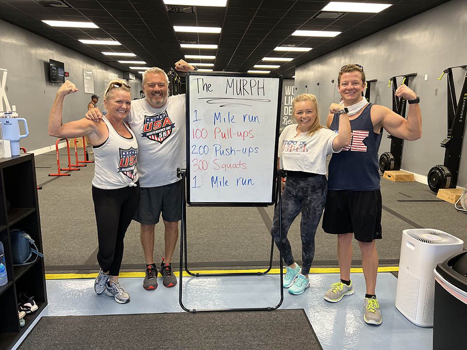 Members of Coastal Fitness posing for photo after a tough workout.