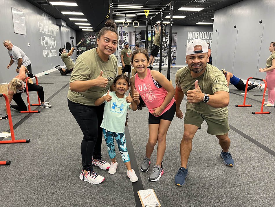 Members of Coastal Fitness posing for photo after a tough workout.