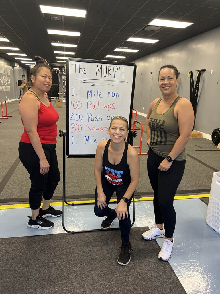 Members of Coastal Fitness posing for photo after a tough workout.