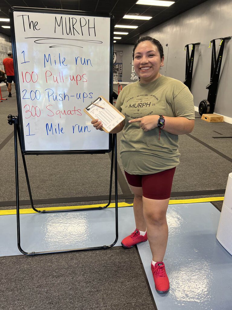 Member of Coastal Fitness poses for photo after a tough workout.