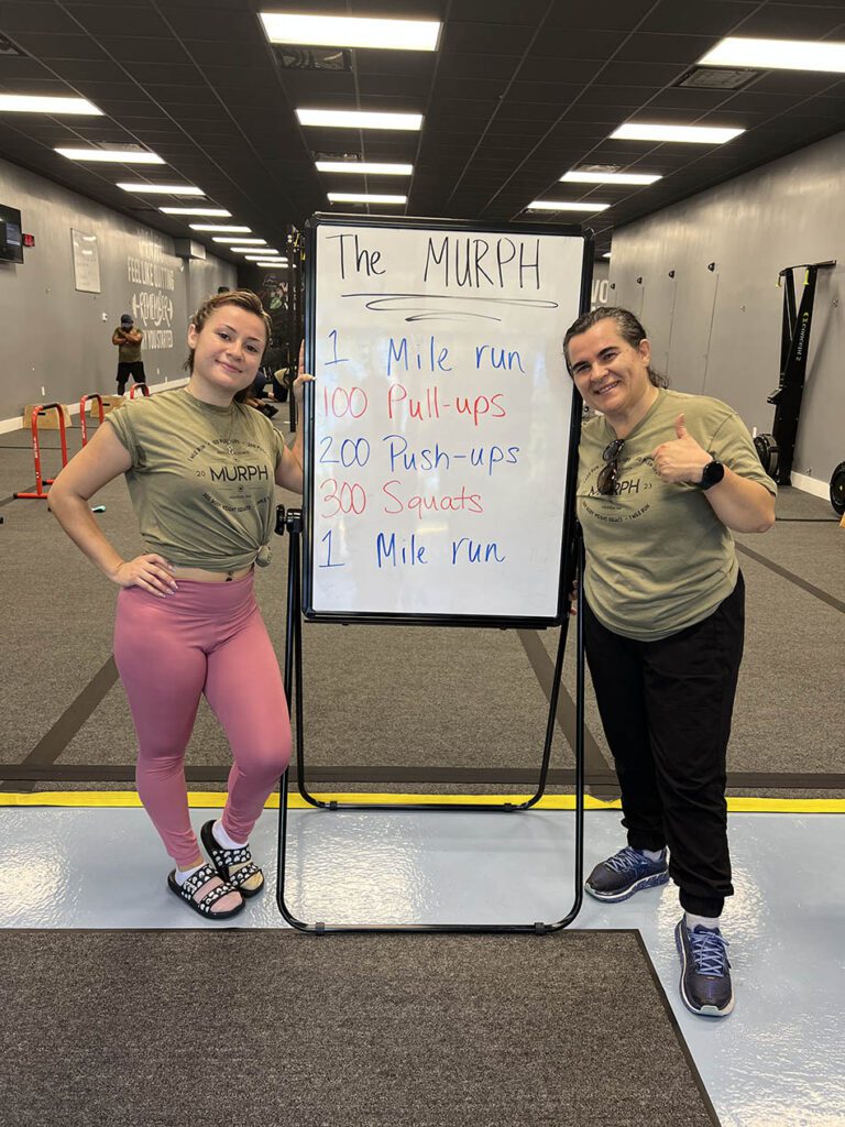 Members of Coastal Fitness posing for photo after a tough workout.