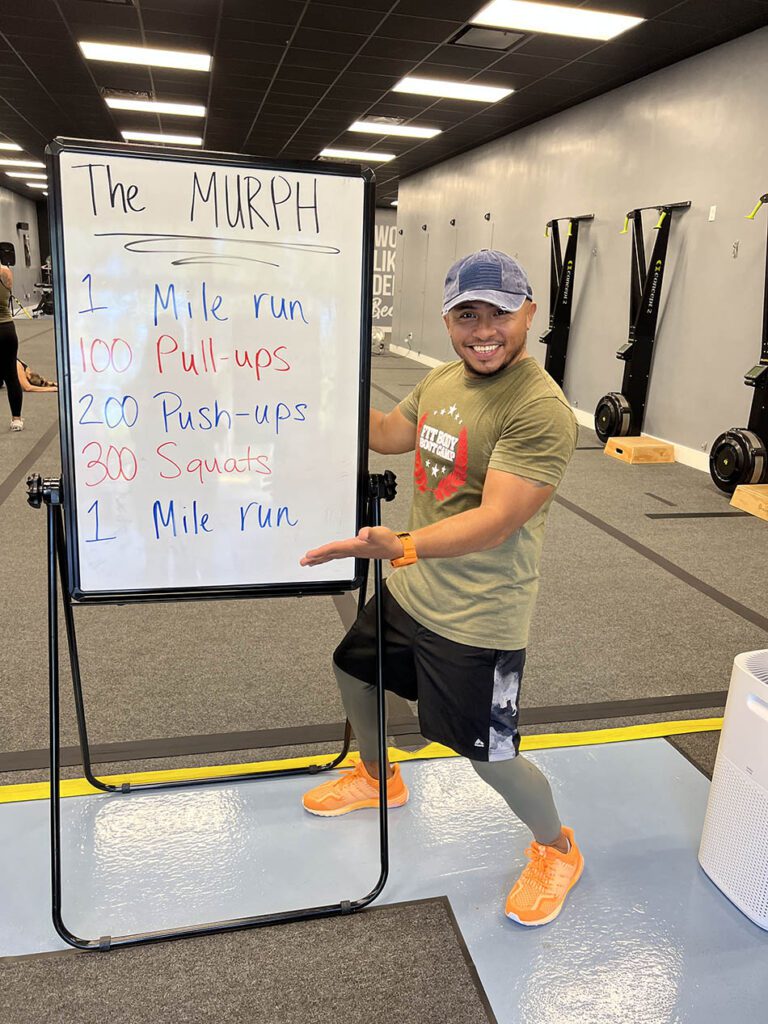 Coach Miko of Coastal Fitness posing for photo after a tough workout.