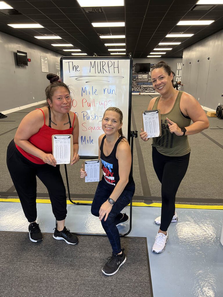 Members of Coastal Fitness posing for photo after a tough workout.