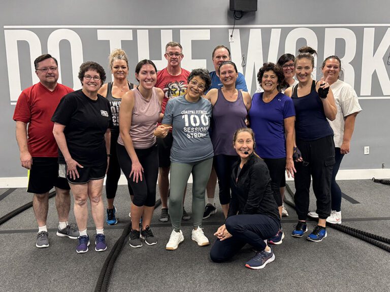 Coastal Fitness members posing for a group photo after strength training